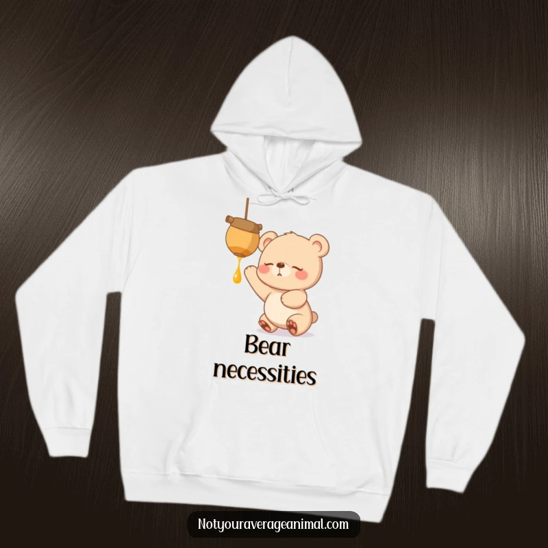 Funny, warm hoodie featuring a sleepy bear cub with eager eyes, reaching up excitedly for a dangling honeypot, symbolizing sweet cravings.