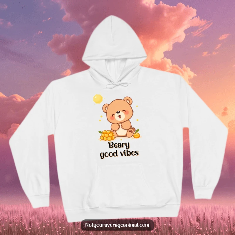 Funny hoodie showcasing a giggling bear cub engrossed in playing with a sweet honeycomb, radiating happiness.