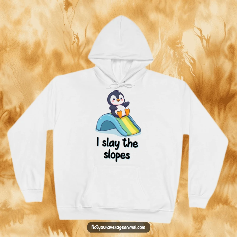 Funny hoodie depicting a joyful penguin in mid-slide down a dazzling rainbow, exuding happiness and warmth.