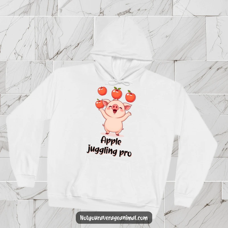Funny small round piglet hoodie showing a cute piglet juggling apples, offering warmth and a touch of hilarious farm humor. A cozy gift.