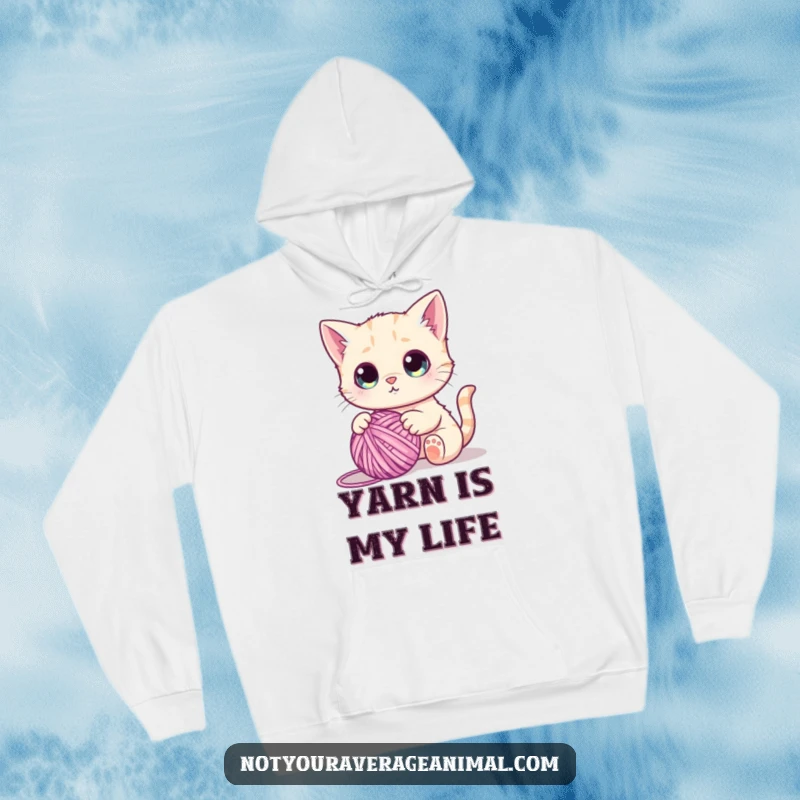 Funny hoodie design of a cute cat with enormous eyes, batting at a large ball of yarn, lost in playful concentration.