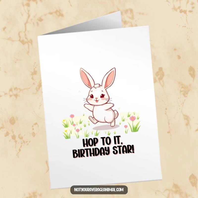 Funny Free Printable Birthday Card: A cheerful rabbit with long, floppy ears hops energetically through a sunny field.