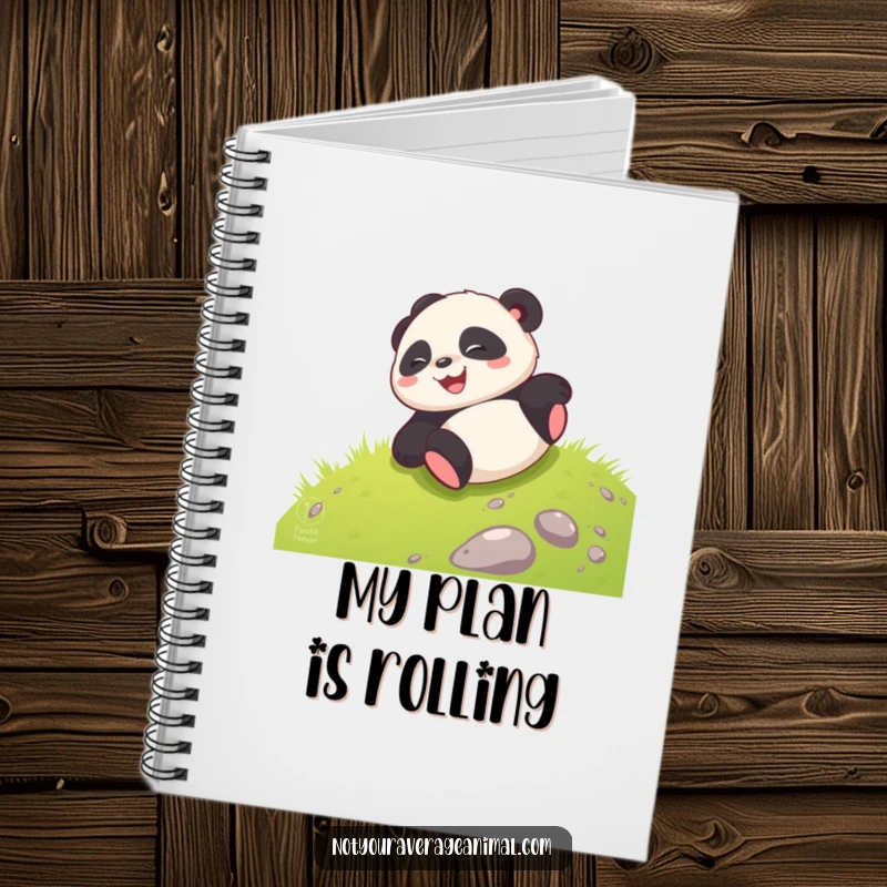 Funny giggling panda cub joyfully rolling down a grassy hill, perfect for a notebook cover.