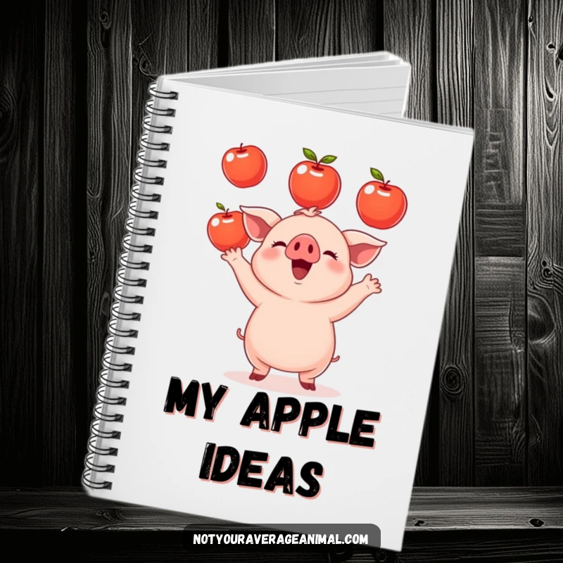 Funny small round piglet notebook cover showing a cheerful piglet juggling shiny apples, inspiring creativity and farm humor. A cute stationery gift.