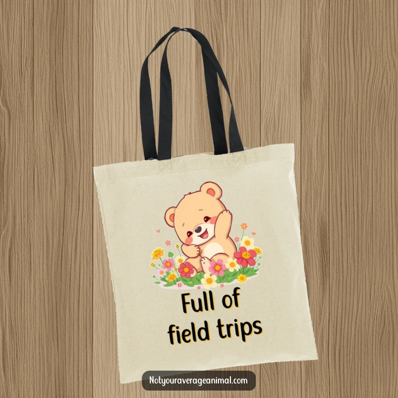 Funny Bear Cub Tote Bag: A happy bear cub tumbles amongst bright flowers, a cheerful and practical accessory for everyday.