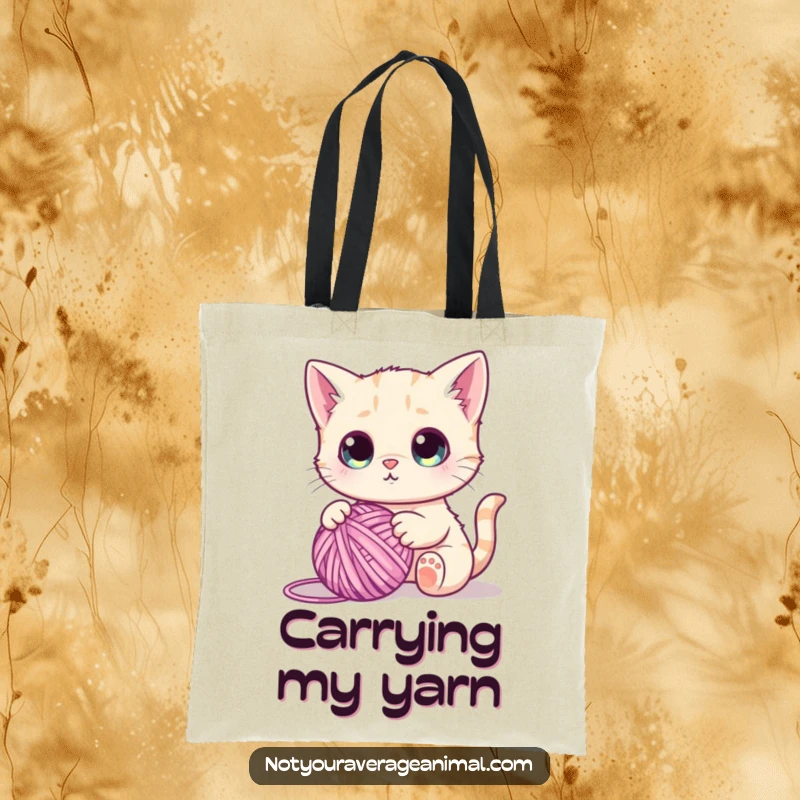 Funny tote bag featuring a cute cat with wide, captivated eyes, playing enthusiastically with a large ball of colorful yarn.