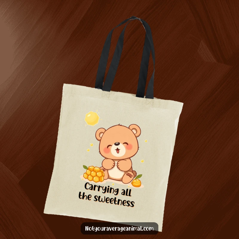 Funny tote bag featuring a jubilant bear cub having a blast with a golden honeycomb, a picture of delight.